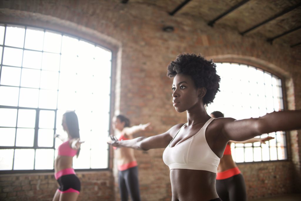 Woman doing arm swings in exercise class with other students